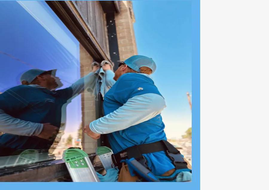 Close-up of a squeegee leaving a streak-free residential window
